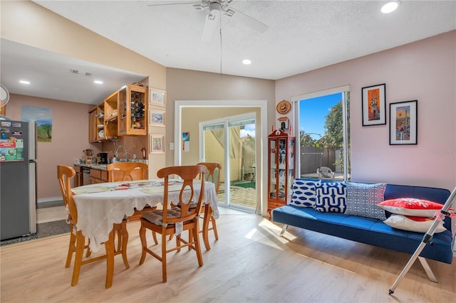 743 Golden Sunshine Cir, Orlando, FL 32807 - dining space with a textured ceiling, ceiling fan, light hardwood / wood-style floors, and vaulted ceiling