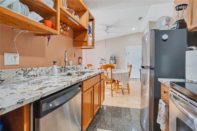 743 Golden Sunshine Cir, Orlando, FL 32807 - kitchen with ceiling fan, sink, stainless steel appliances, light stone counters, and lofted ceiling