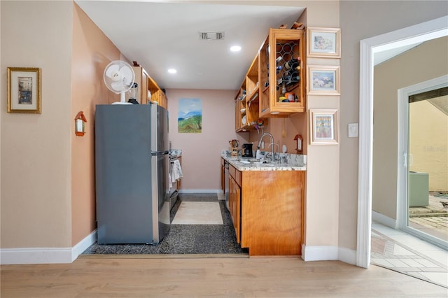 743 Golden Sunshine Cir, Orlando, FL 32807 - kitchen with stainless steel fridge, light hardwood / wood-style floors, and sink