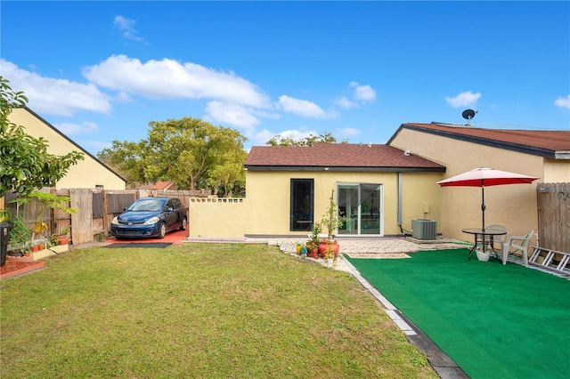 743 Golden Sunshine Cir, Orlando, FL 32807 - rear view of property featuring a yard and central AC unit