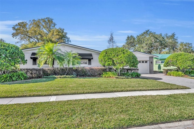 view of front of property featuring a front yard and a garage