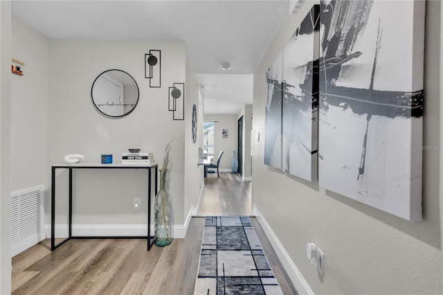 corridor with light hardwood / wood-style flooring