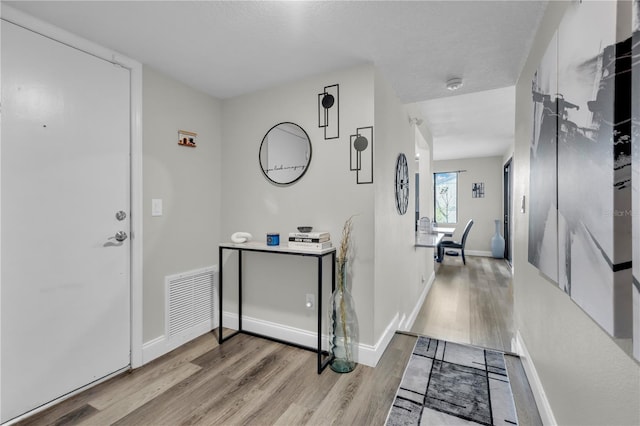 foyer entrance with light wood-type flooring