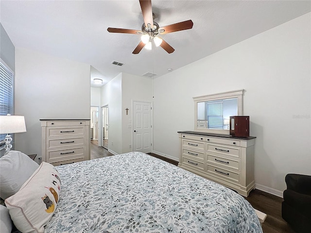 bedroom featuring ceiling fan, dark wood finished floors, visible vents, and baseboards