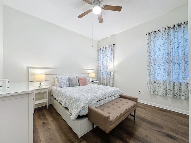 bedroom with ceiling fan, vaulted ceiling, dark wood finished floors, and baseboards