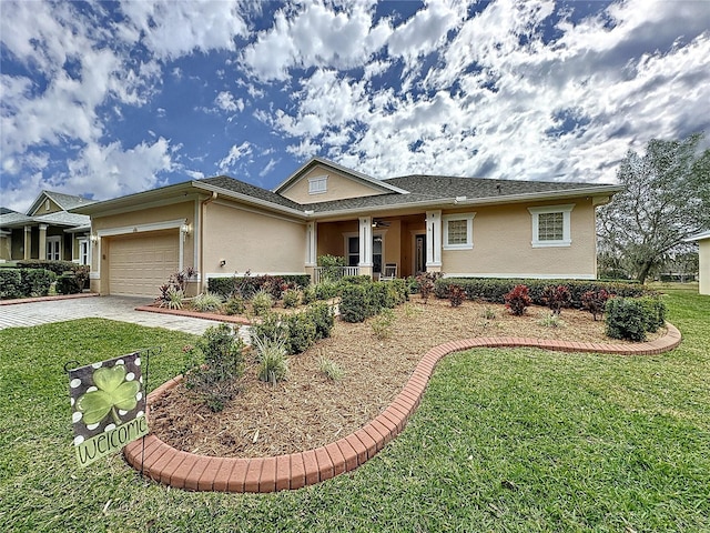 single story home featuring a garage, a front yard, driveway, and stucco siding