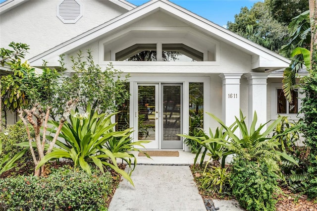 property entrance with stucco siding