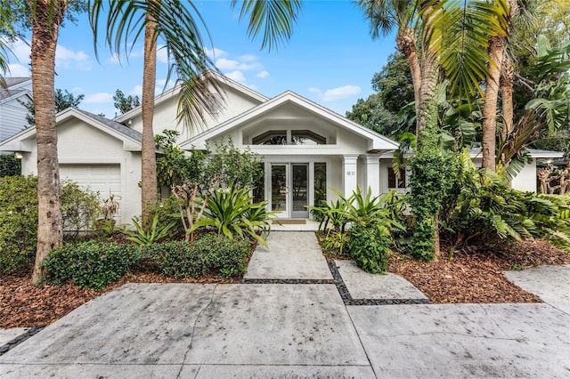 view of front of home with french doors and a garage