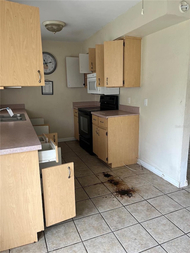 kitchen with black electric range, light brown cabinets, light tile patterned floors, and sink