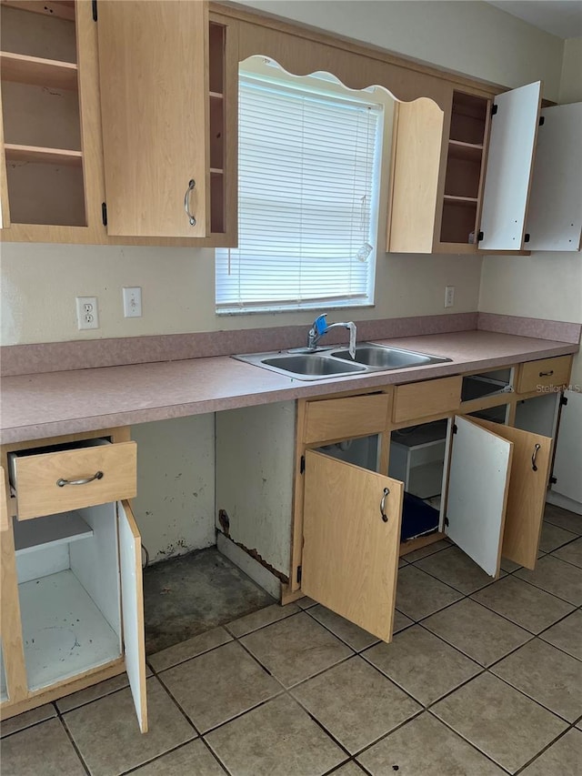 kitchen featuring light tile patterned floors and sink