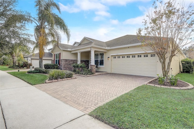 view of front facade with a front yard and a garage