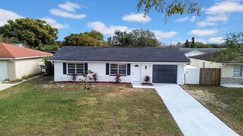 ranch-style house with a front yard and a garage