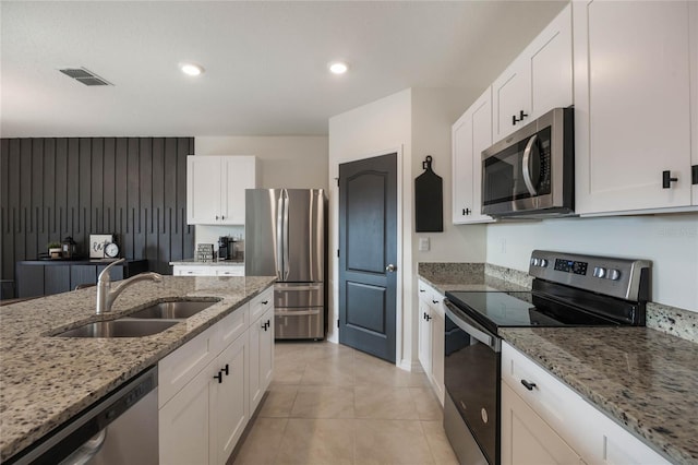 kitchen featuring stainless steel appliances, white cabinets, and sink