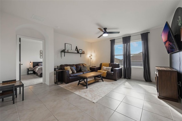 tiled living room featuring ceiling fan