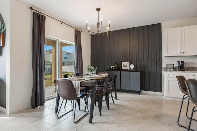 dining room featuring light tile patterned flooring and a chandelier