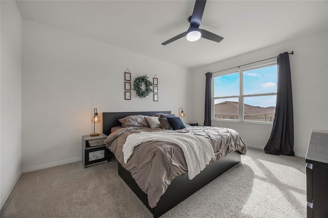 bedroom featuring light carpet and ceiling fan