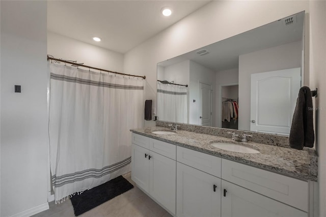 bathroom with a shower with shower curtain, tile patterned flooring, and vanity