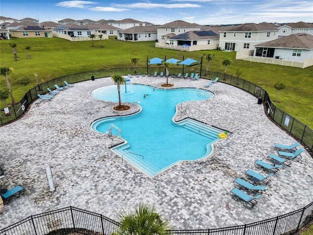 view of pool with a yard