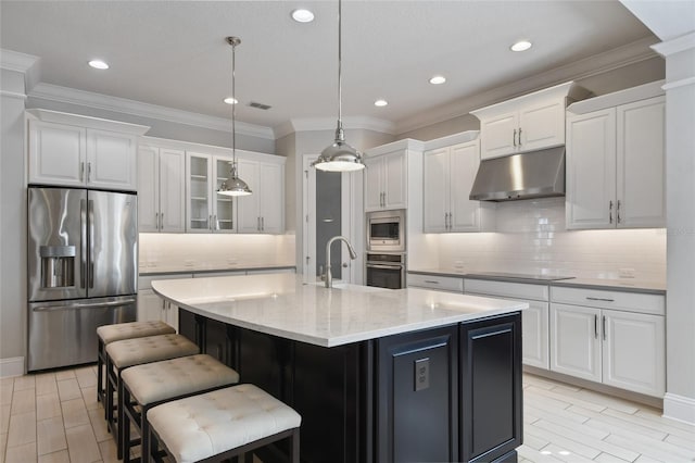 kitchen with sink, hanging light fixtures, a center island with sink, stainless steel appliances, and white cabinets