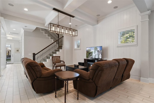 living room with ornate columns, crown molding, beam ceiling, and light hardwood / wood-style flooring