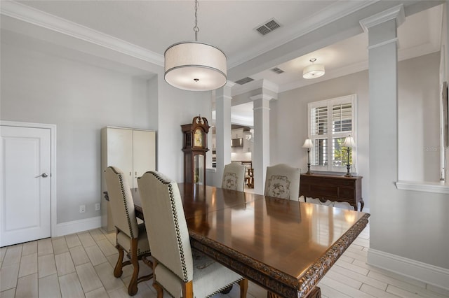 dining space with ornamental molding and ornate columns