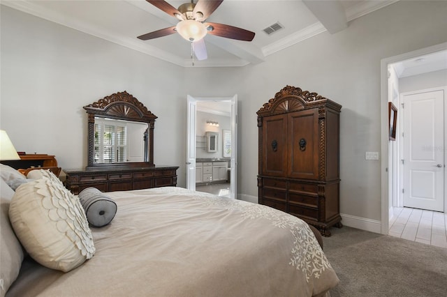 bedroom featuring crown molding, ensuite bath, carpet flooring, ceiling fan, and beam ceiling