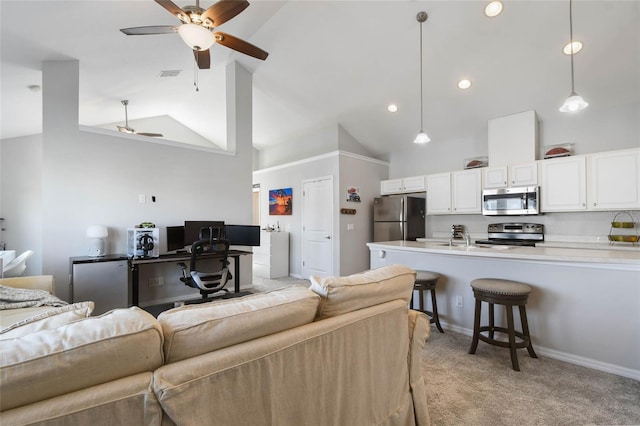 carpeted living room featuring sink, high vaulted ceiling, and ceiling fan