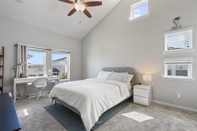 carpeted bedroom featuring multiple windows, high vaulted ceiling, and ceiling fan