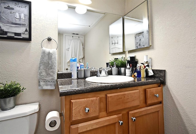 bathroom with vanity and toilet