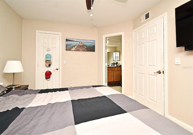 bedroom featuring ceiling fan, a closet, and a textured ceiling