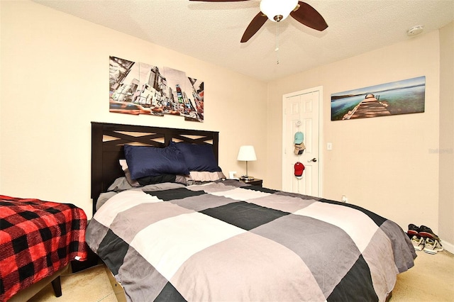 bedroom with light carpet, a textured ceiling, and ceiling fan