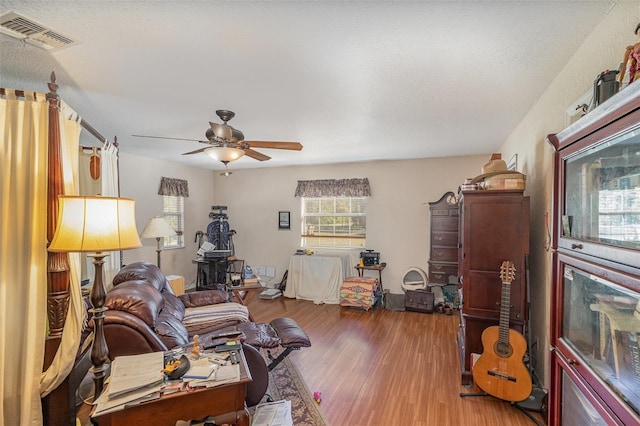 living room with hardwood / wood-style flooring and ceiling fan