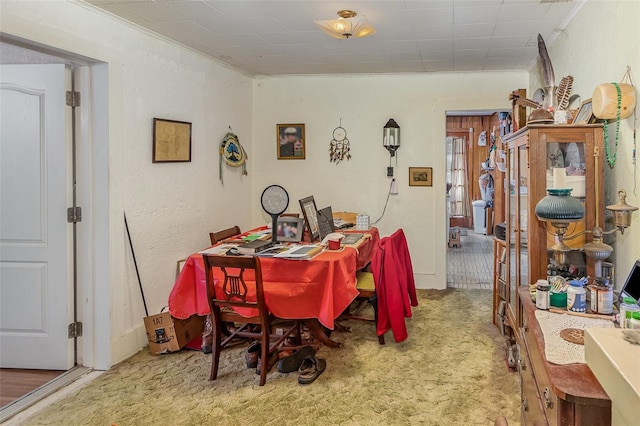 dining room featuring ornamental molding and carpet flooring