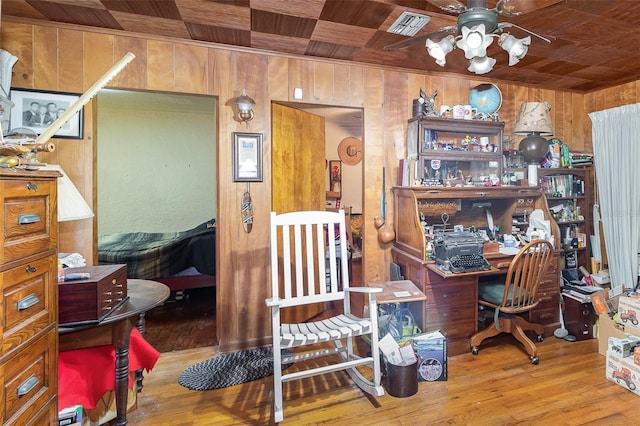 office space with hardwood / wood-style flooring, ceiling fan, wood ceiling, and wood walls