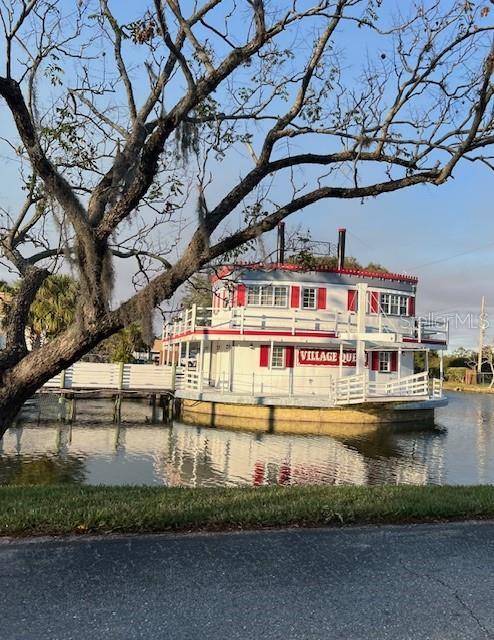 back of property featuring a water view