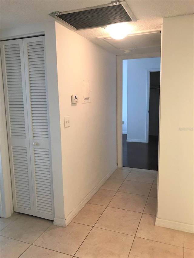 hallway featuring light tile patterned flooring