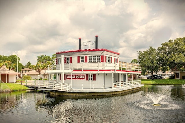 rear view of property featuring a water view