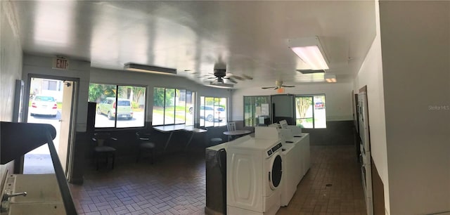 kitchen featuring white cabinets, washer and clothes dryer, and ceiling fan