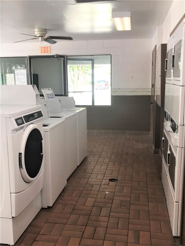 washroom with washer and clothes dryer, ceiling fan, and stacked washing maching and dryer