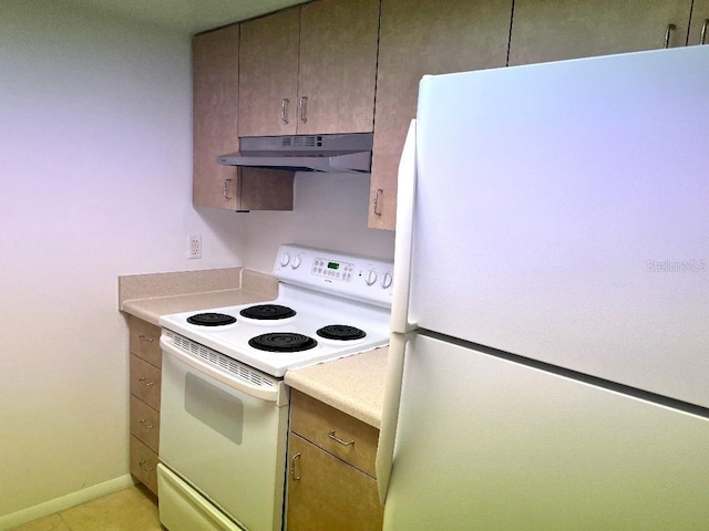 kitchen with white appliances and light tile patterned floors