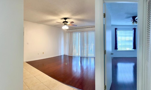 unfurnished room featuring ceiling fan, a textured ceiling, and light tile patterned floors