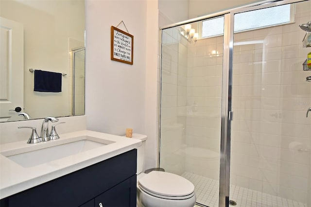 bathroom featuring walk in shower, vanity, and toilet