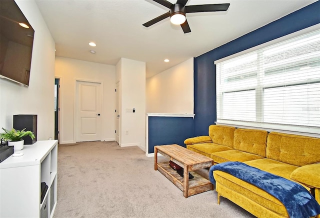 carpeted living room featuring ceiling fan