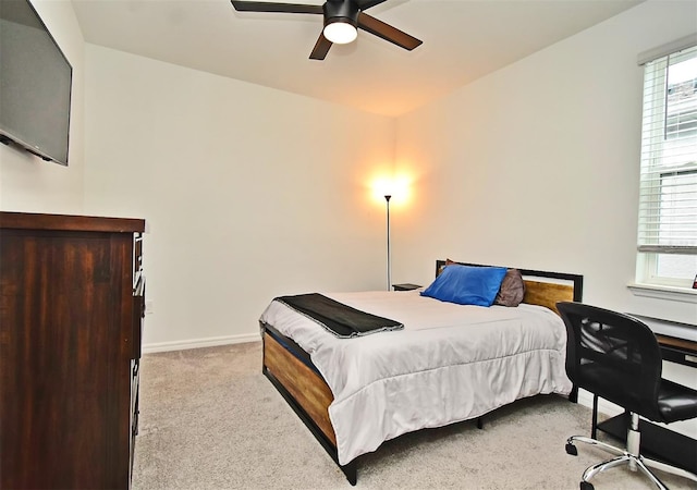 carpeted bedroom with multiple windows and ceiling fan