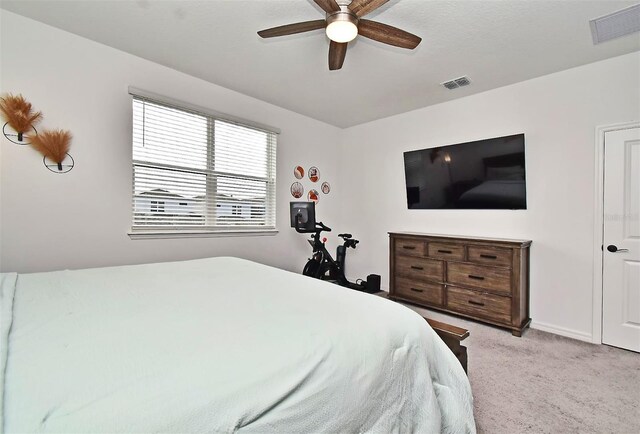 bedroom with ceiling fan and light colored carpet