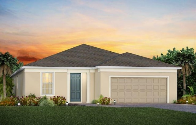 view of front of home with a lawn and a garage