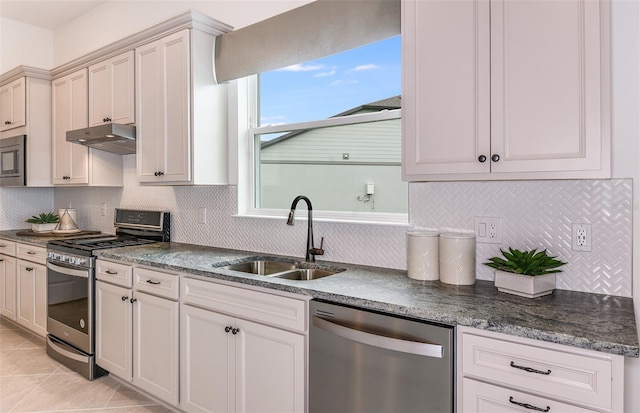 kitchen featuring decorative backsplash, light tile patterned floors, sink, and appliances with stainless steel finishes