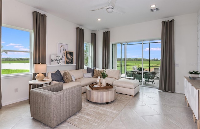 tiled living room featuring ceiling fan