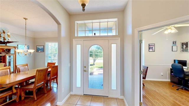 foyer with a chandelier and light wood-type flooring