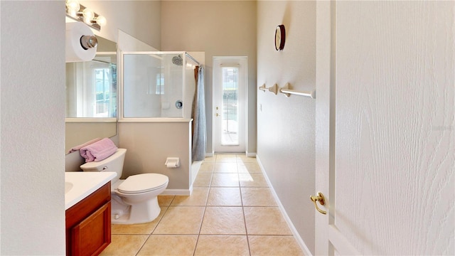 bathroom with a shower with door, vanity, tile patterned floors, and toilet